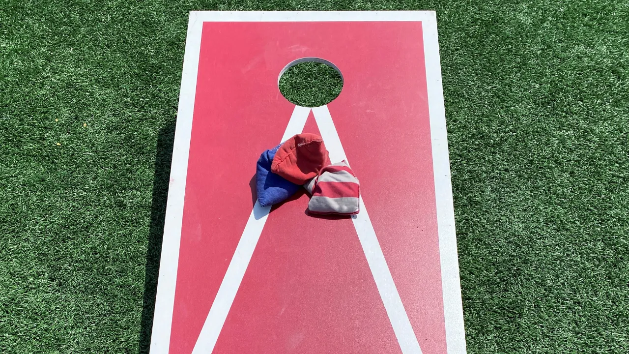 Red cornhole with beanbags capturing the laid-back vibe of cornhole Austin style games.