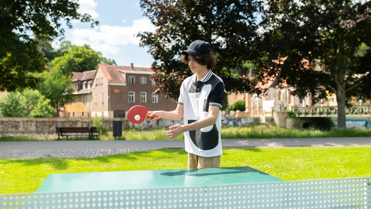 Teen enjoying outdoor ping pong in Austin's food truck park Hungry Hollow