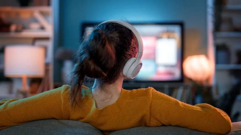 Woman Watching TV with Wireless Headphones at Home
